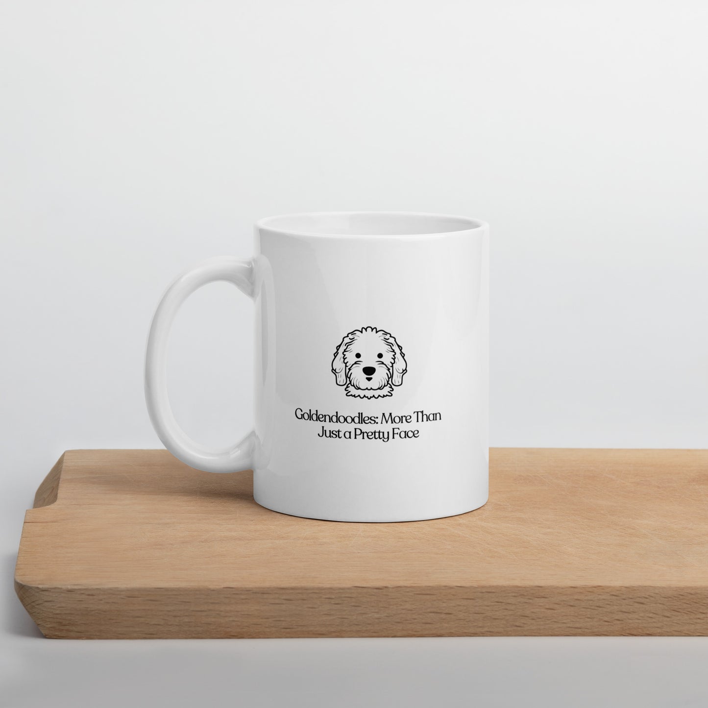 white color glossy ceramic mug that says goldendoodle more than just a pretty face on a table