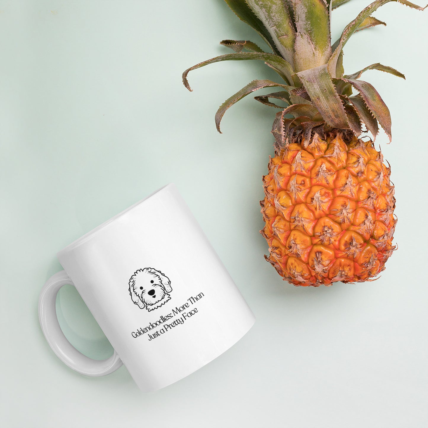 white color glossy ceramic mug that says goldendoodle more than just a pretty face with a pineapple on the side